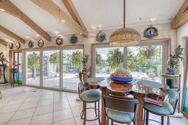 116 Dunes Edge Rd, Jupiter, FL 33477 - dining area with light tile patterned floors, beamed ceiling, and a textured ceiling