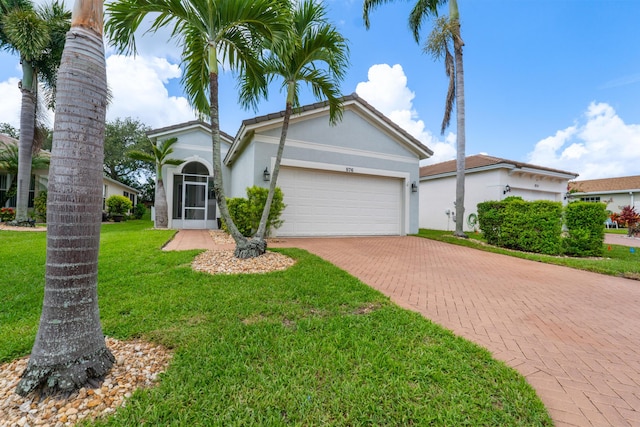 876 SW Rocky Bayou Ter, Port Saint Lucie, FL 34986 - view of front facade with an attached garage, decorative driveway, stucco siding, and a front yard