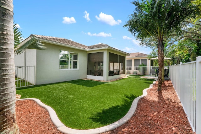 876 SW Rocky Bayou Ter, Port Saint Lucie, FL 34986 - back of house featuring a sunroom, stucco siding, and a fenced backyard