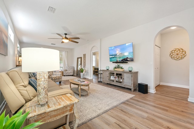 876 SW Rocky Bayou Ter, Port Saint Lucie, FL 34986 - living room with arched walkways, a ceiling fan, and light wood-style flooring
