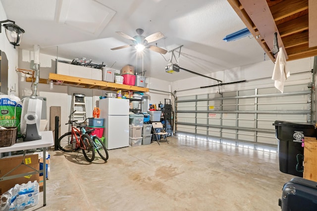 876 SW Rocky Bayou Ter, Port Saint Lucie, FL 34986 - garage with freestanding refrigerator, a garage door opener, and a ceiling fan