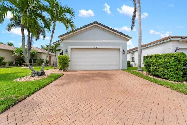 876 SW Rocky Bayou Ter, Port Saint Lucie, FL 34986 - single story home with decorative driveway, a front lawn, stucco siding, and an attached garage