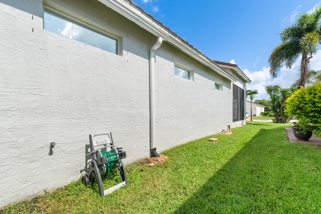 876 SW Rocky Bayou Ter, Port Saint Lucie, FL 34986 - view of side of home featuring stucco siding and a lawn