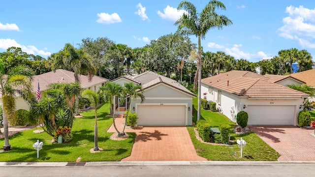 876 SW Rocky Bayou Ter, Port Saint Lucie, FL 34986 - ranch-style home with decorative driveway, stucco siding, an attached garage, and a front yard