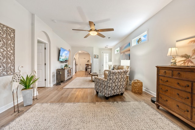 876 SW Rocky Bayou Ter, Port Saint Lucie, FL 34986 - living area featuring arched walkways, wood finished floors, and ceiling fan