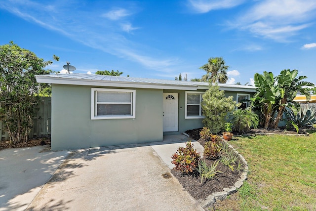 1157 NW 14th Ter, Stuart, FL 34994 - ranch-style home featuring stucco siding and a metal roof