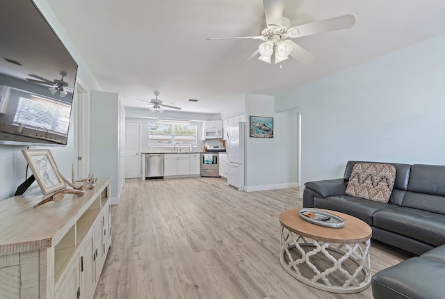1157 NW 14th Ter, Stuart, FL 34994 - living room featuring ceiling fan and light wood-style floors