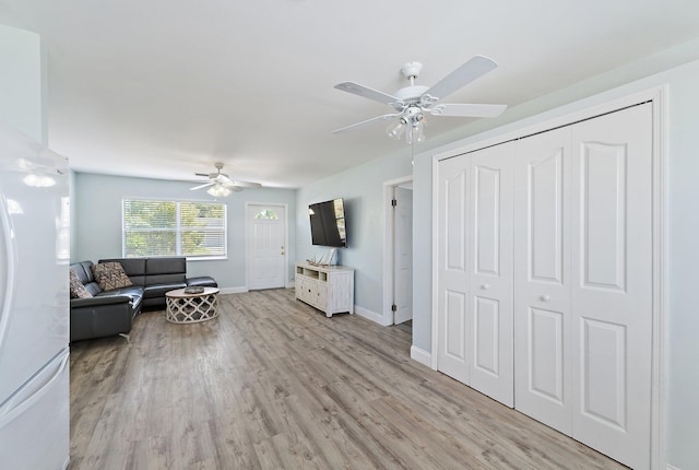 1157 NW 14th Ter, Stuart, FL 34994 - living room with a ceiling fan and light wood-style flooring