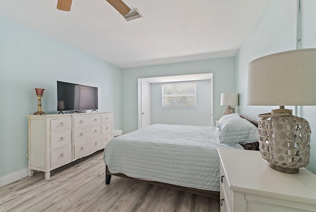 1157 NW 14th Ter, Stuart, FL 34994 - bedroom with light wood finished floors and a ceiling fan
