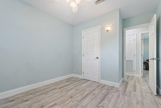 1157 NW 14th Ter, Stuart, FL 34994 - unfurnished bedroom featuring light wood finished floors and ceiling fan
