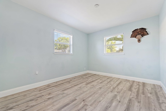 1157 NW 14th Ter, Stuart, FL 34994 - spare room featuring light wood-style flooring and baseboards