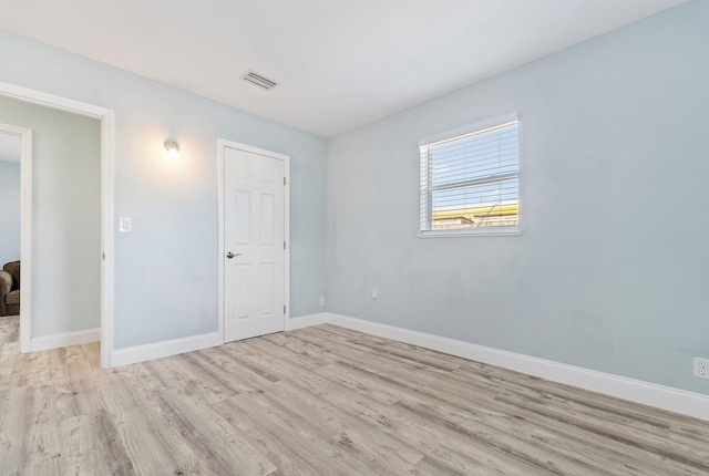 1157 NW 14th Ter, Stuart, FL 34994 - unfurnished bedroom featuring light wood finished floors and baseboards