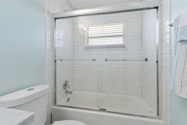 1157 NW 14th Ter, Stuart, FL 34994 - bathroom with toilet and bath / shower combo with glass door