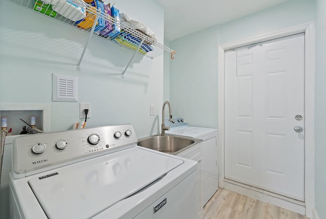 1157 NW 14th Ter, Stuart, FL 34994 - washroom featuring light wood-style floors and washing machine and dryer