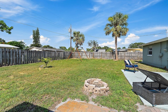 1157 NW 14th Ter, Stuart, FL 34994 - fenced backyard with a fire pit and a patio area
