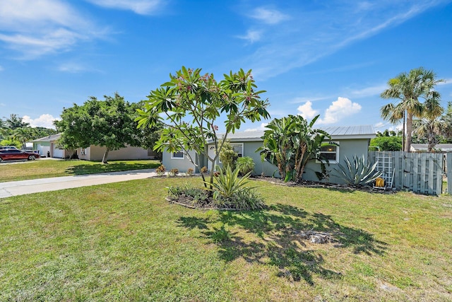 1157 NW 14th Ter, Stuart, FL 34994 - view of front facade with driveway, stucco siding, and a metal roof