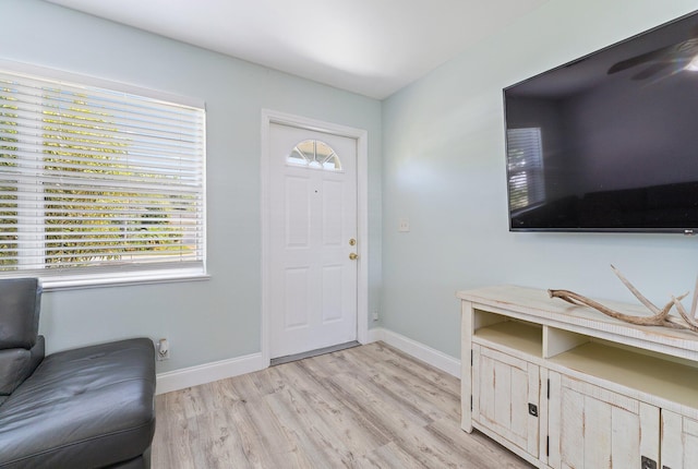 1157 NW 14th Ter, Stuart, FL 34994 - entrance foyer with light wood finished floors and baseboards