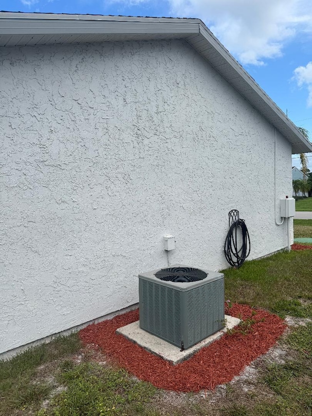 327 NE Surfside Ave, Port Saint Lucie, FL 34983 - view of home's exterior featuring stucco siding and a central air condition unit