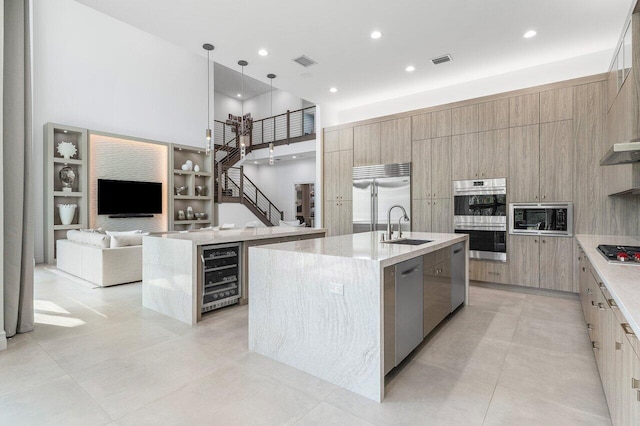 17432 Ponte Chiasso Dr, Boca Raton, FL 33496 - kitchen featuring modern cabinets, beverage cooler, built in appliances, a large island with sink, and open floor plan