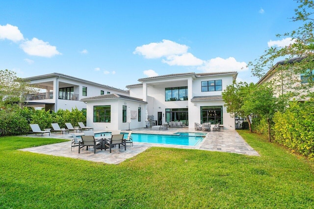 17432 Ponte Chiasso Dr, Boca Raton, FL 33496 - rear view of property with a patio area, an outdoor pool, stucco siding, and a lawn