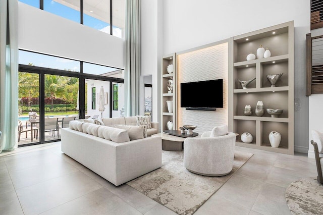 17432 Ponte Chiasso Dr, Boca Raton, FL 33496 - living room with built in shelves, a high ceiling, and tile patterned flooring