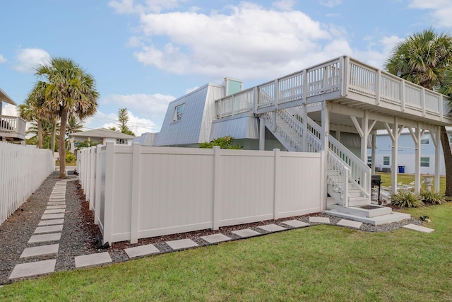 346 Hernando St, Hutchinson Island, FL 34949 - rear view of property with stairs, a fenced backyard, and a deck