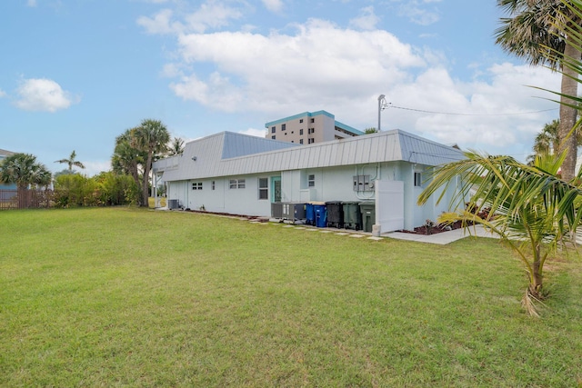 346 Hernando St, Hutchinson Island, FL 34949 - back of house featuring a lawn and a metal roof
