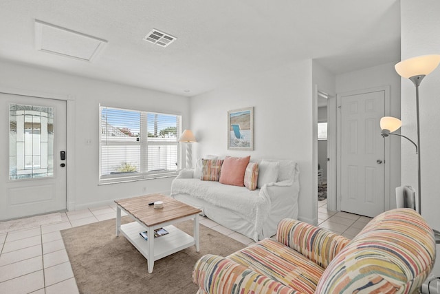 346 Hernando St, Hutchinson Island, FL 34949 - living area featuring light tile patterned floors and attic access