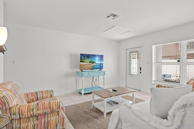 346 Hernando St, Hutchinson Island, FL 34949 - tiled living room with attic access and baseboards