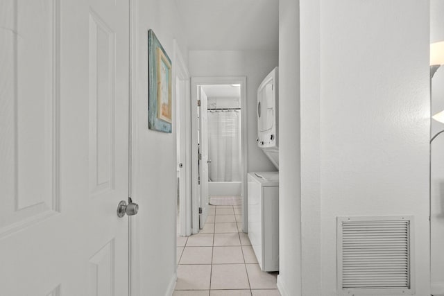 346 Hernando St, Hutchinson Island, FL 34949 - washroom featuring stacked washer and clothes dryer and light tile patterned flooring