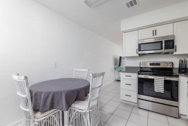 346 Hernando St, Hutchinson Island, FL 34949 - kitchen featuring appliances with stainless steel finishes, white cabinetry, and light tile patterned floors