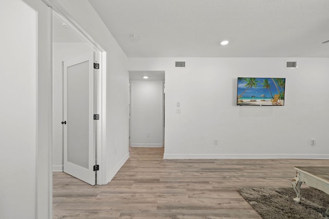 346 Hernando St, Hutchinson Island, FL 34949 - unfurnished living room with light wood-style floors and recessed lighting
