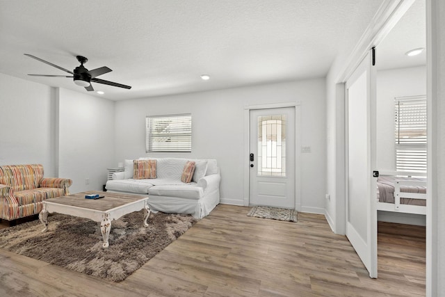 346 Hernando St, Hutchinson Island, FL 34949 - living room with light wood finished floors, ceiling fan, and recessed lighting