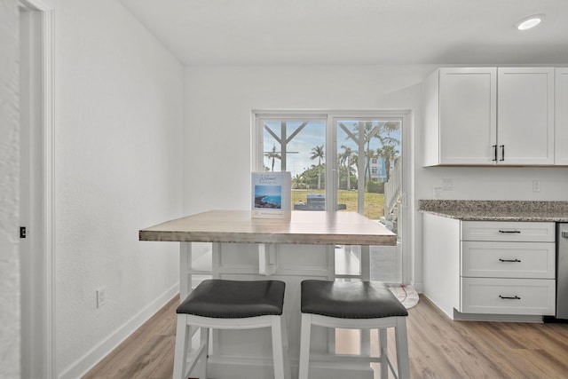 346 Hernando St, Hutchinson Island, FL 34949 - dining room featuring baseboards and light wood-style floors