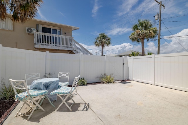 346 Hernando St, Hutchinson Island, FL 34949 - fenced backyard featuring a patio area, a gate, and outdoor dining area