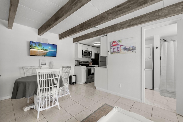 346 Hernando St, Hutchinson Island, FL 34949 - dining space featuring stacked washer / drying machine, beam ceiling, and light tile patterned flooring