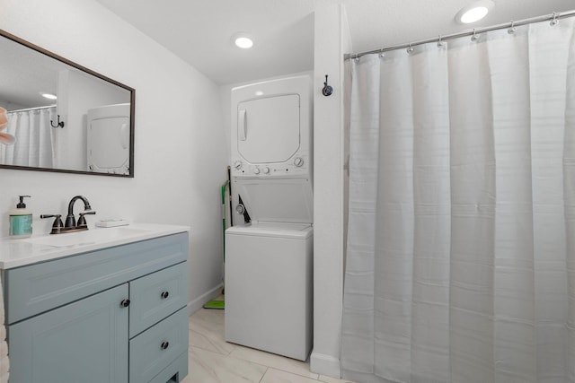 346 Hernando St, Hutchinson Island, FL 34949 - bathroom featuring stacked washer / drying machine, vanity, marble finish flooring, and a shower with curtain