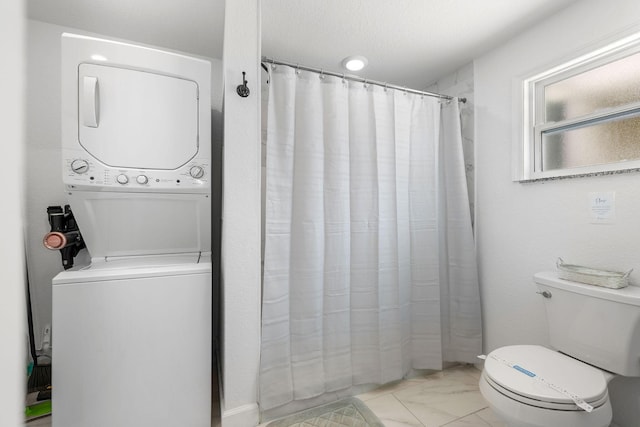 346 Hernando St, Hutchinson Island, FL 34949 - full bathroom with stacked washing machine and dryer, marble look tiles, and a shower with shower curtain