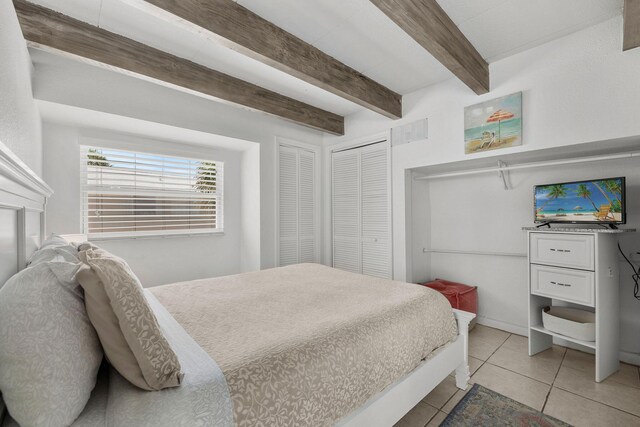 346 Hernando St, Hutchinson Island, FL 34949 - bedroom featuring light tile patterned floors and beamed ceiling