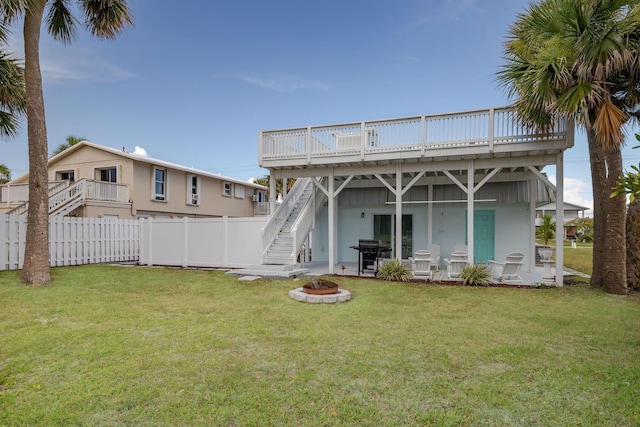 346 Hernando St, Hutchinson Island, FL 34949 - rear view of property with a fire pit, a wooden deck, and stairs