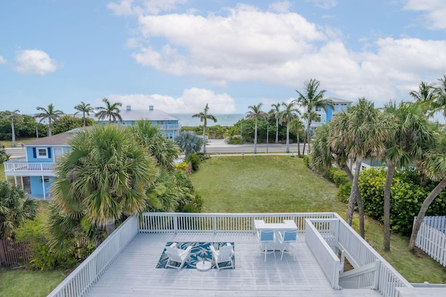 346 Hernando St, Hutchinson Island, FL 34949 - wooden terrace featuring outdoor dining space and a lawn