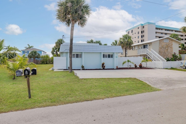 346 Hernando St, Hutchinson Island, FL 34949 - art deco home with stucco siding and driveway
