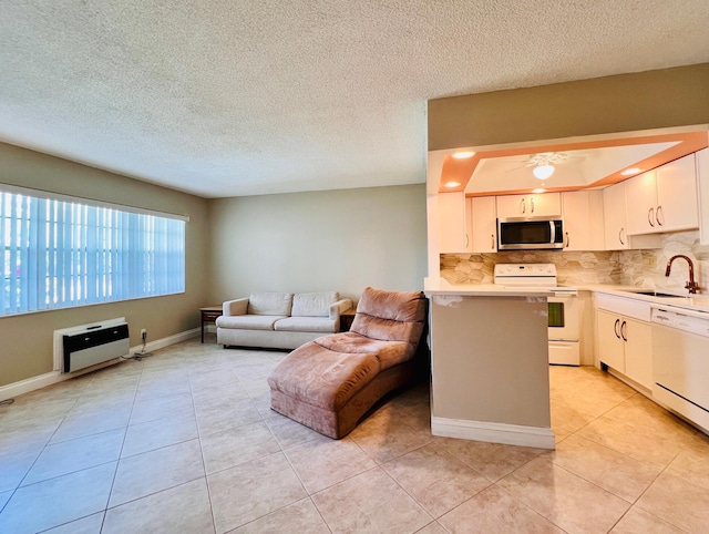 304 Sheffield M, West Palm Beach, FL 33417 - kitchen featuring white appliances, light countertops, tasteful backsplash, open floor plan, and light tile patterned flooring