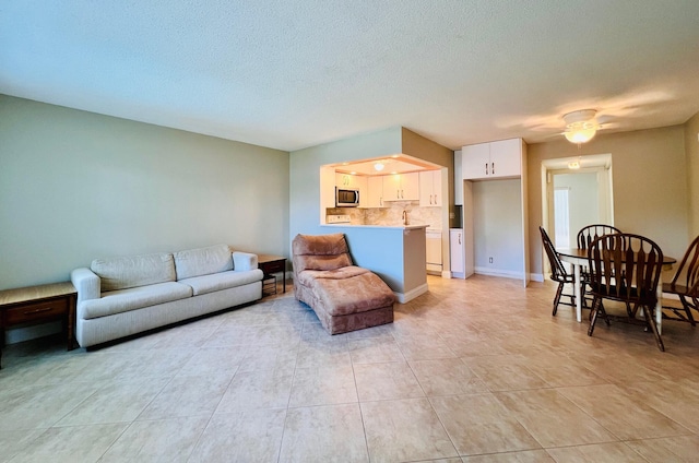 304 Sheffield M, West Palm Beach, FL 33417 - living area with light tile patterned floors and a textured ceiling