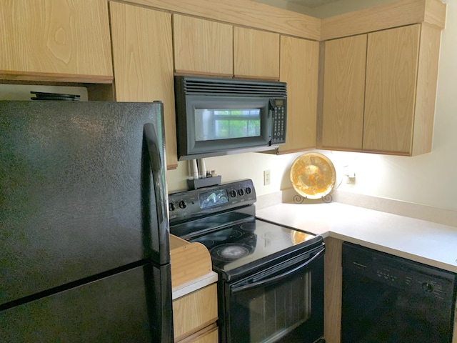 101 Liberty Ct, Deerfield Beach, FL 33442 - kitchen with black appliances, light brown cabinetry, and light countertops