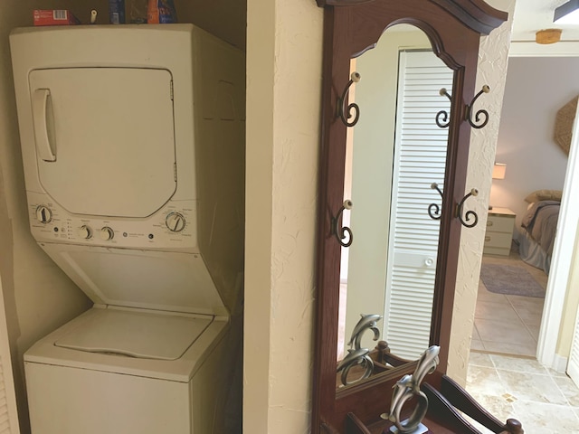 101 Liberty Ct, Deerfield Beach, FL 33442 - laundry area featuring stacked washing machine and dryer and light tile patterned floors