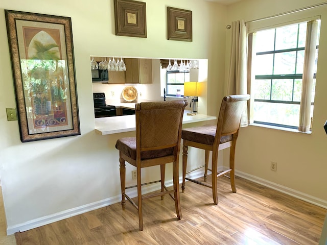 101 Liberty Ct, Deerfield Beach, FL 33442 - dining area with light wood finished floors and a bar