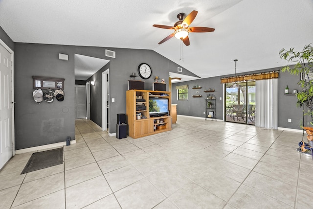 1882 SW Agnes St, Port Saint Lucie, FL 34953 - living room with a ceiling fan, vaulted ceiling, and light tile patterned floors