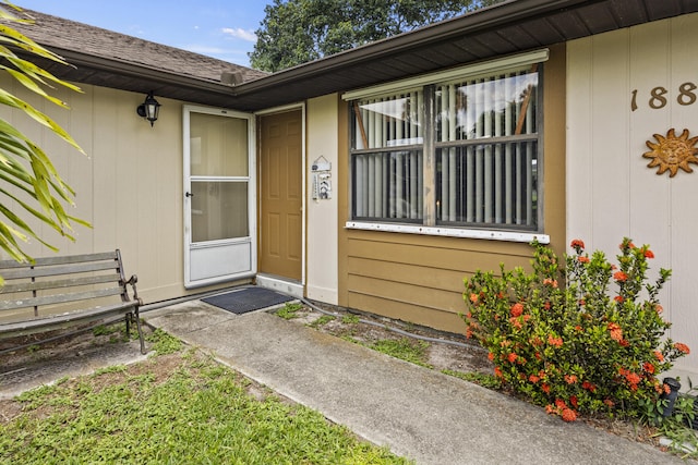 1882 SW Agnes St, Port Saint Lucie, FL 34953 - view of exterior entry with roof with shingles