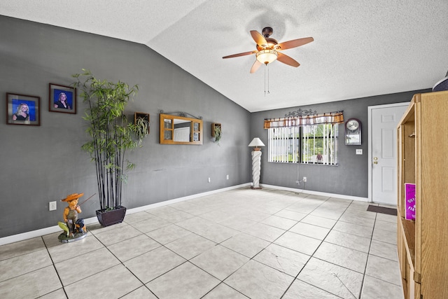 1882 SW Agnes St, Port Saint Lucie, FL 34953 - tiled spare room featuring vaulted ceiling, a ceiling fan, and a textured ceiling